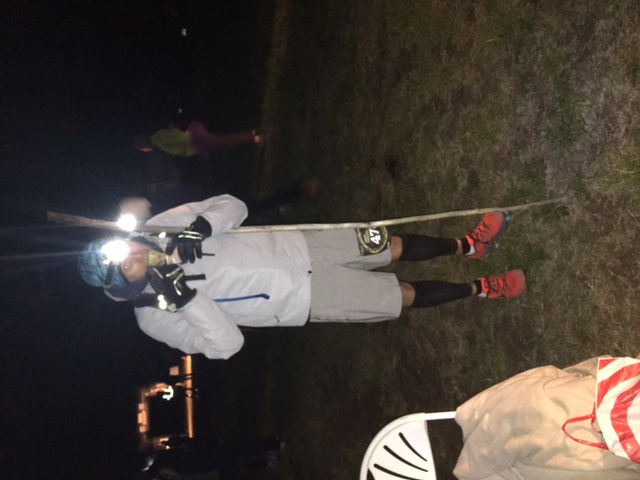 Robert at mile 78 of the Leadville 100, eating ramen with a walking stick.